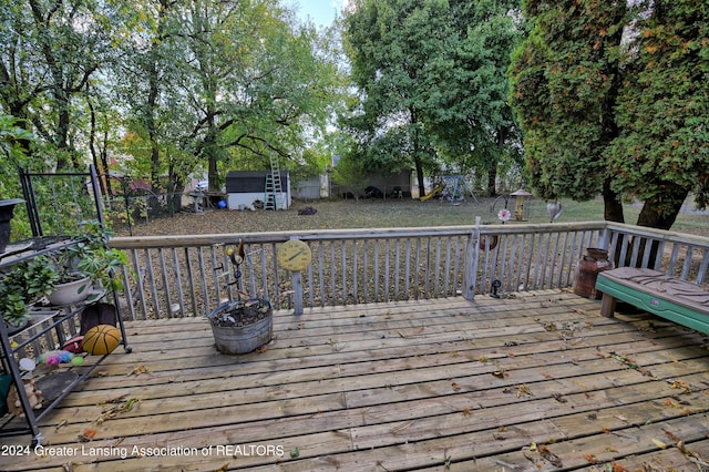 wooden deck with an outbuilding and a shed