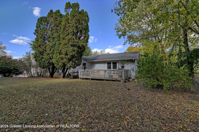 back of property with a wooden deck