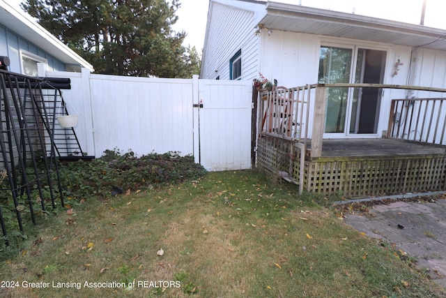 view of side of home with a yard