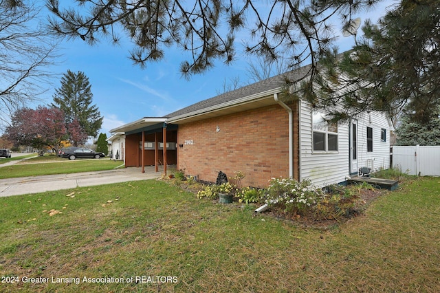 view of home's exterior featuring a yard and a carport