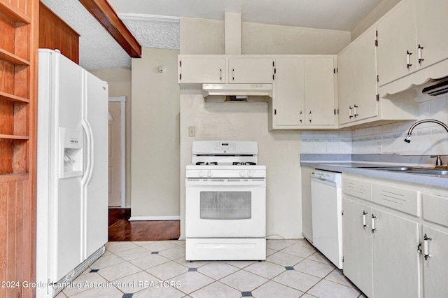 kitchen with light tile patterned flooring, white cabinetry, a textured ceiling, sink, and white appliances