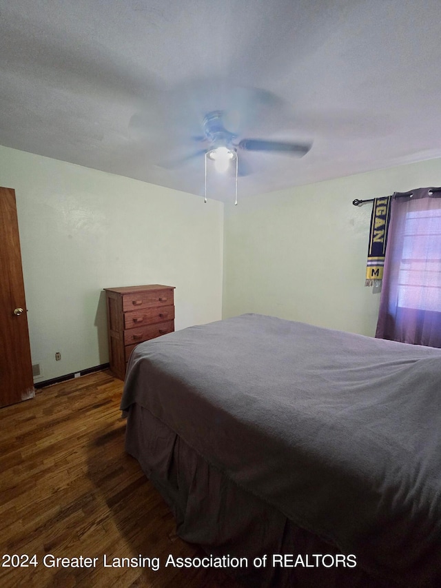 bedroom featuring ceiling fan and dark hardwood / wood-style flooring