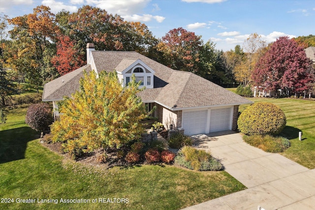 view of front of house with a front lawn and a garage