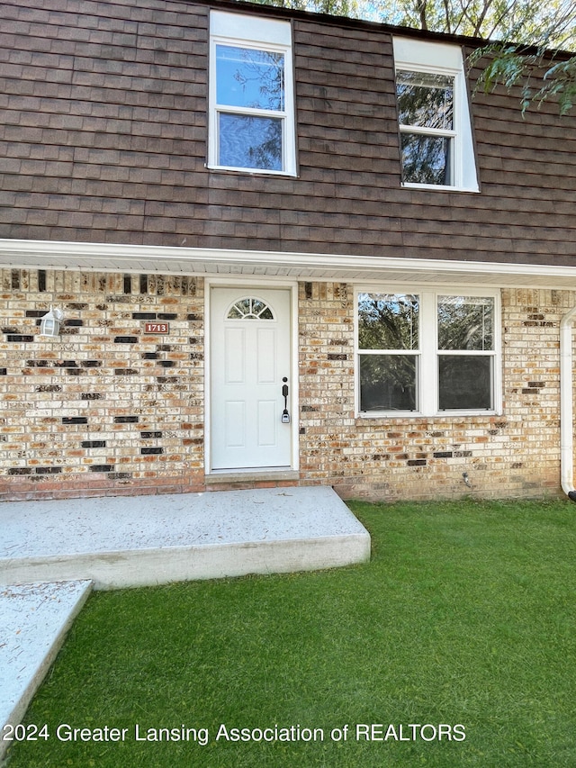 entrance to property with a yard