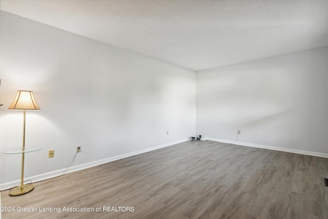 unfurnished room with wood-type flooring