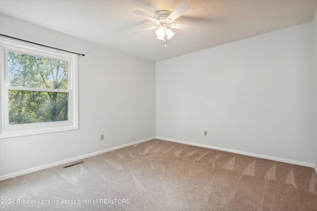 spare room featuring carpet floors and ceiling fan