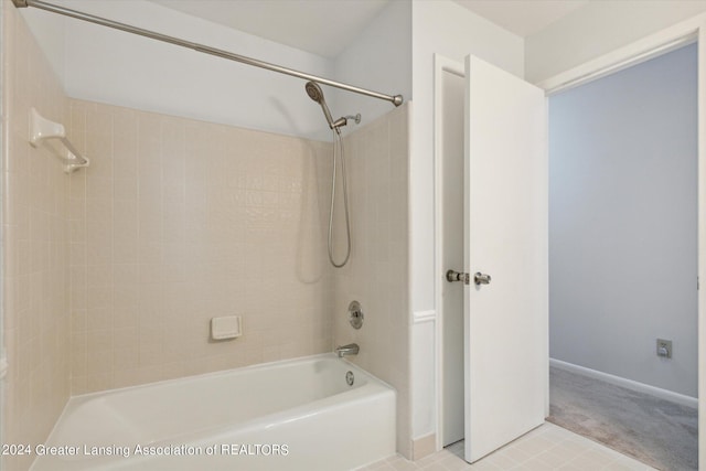 bathroom featuring tiled shower / bath and tile patterned floors