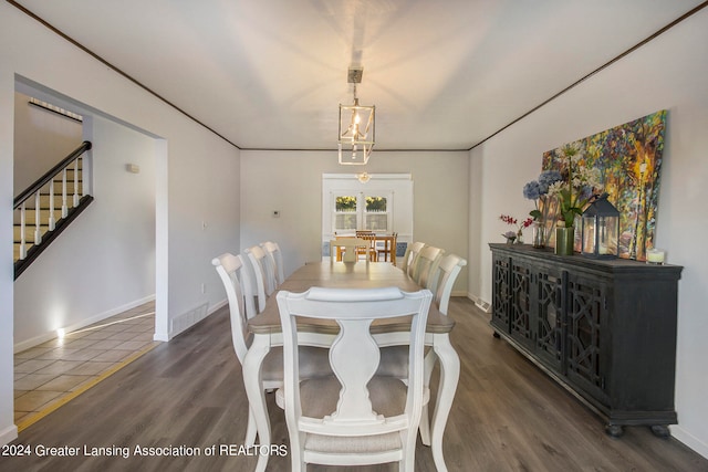 dining room with an inviting chandelier and dark hardwood / wood-style flooring