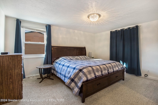 carpeted bedroom featuring a textured ceiling