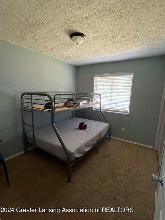 carpeted bedroom with a textured ceiling