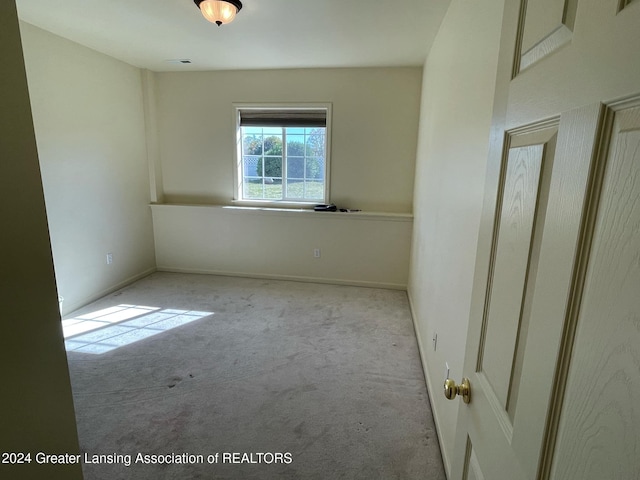 unfurnished room with light colored carpet