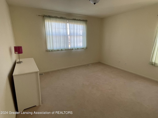 empty room with light colored carpet