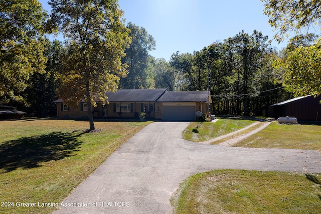 view of front of property with a front lawn and a garage