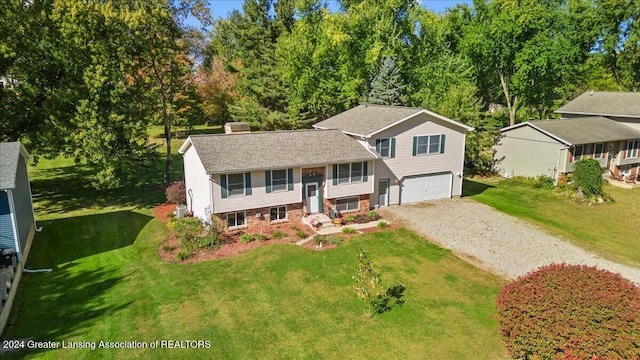 raised ranch with a garage and a front lawn