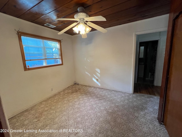 spare room featuring ceiling fan, wood ceiling, and light colored carpet