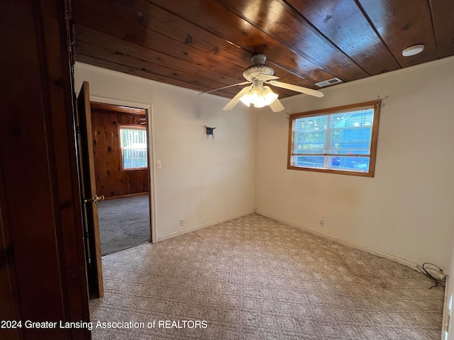 unfurnished room with ceiling fan, wood ceiling, and light carpet