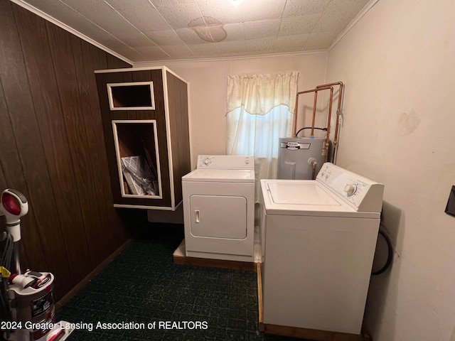 laundry room with crown molding, separate washer and dryer, electric water heater, and wooden walls