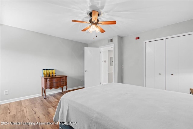 bedroom with ceiling fan, light wood-type flooring, and a closet