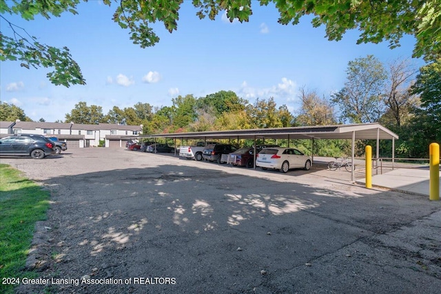 view of parking / parking lot featuring a carport