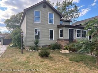 rear view of property with a yard