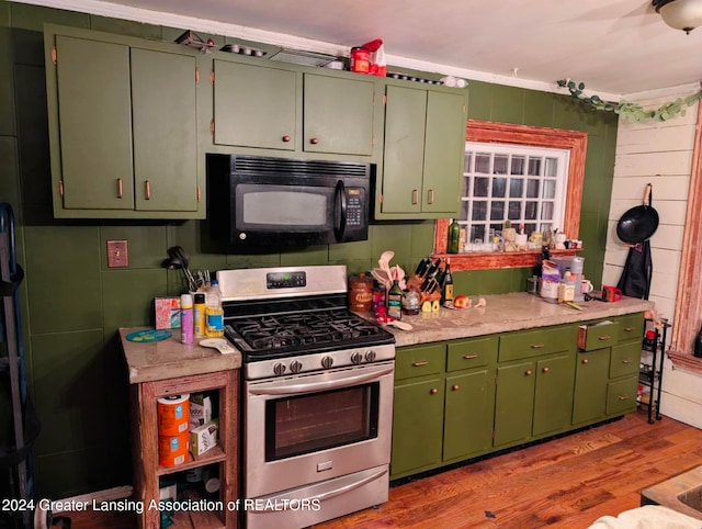 kitchen with light hardwood / wood-style floors, gas range, and green cabinetry