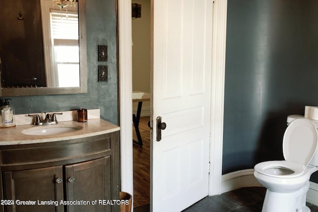 bathroom featuring tile patterned floors, vanity, and toilet