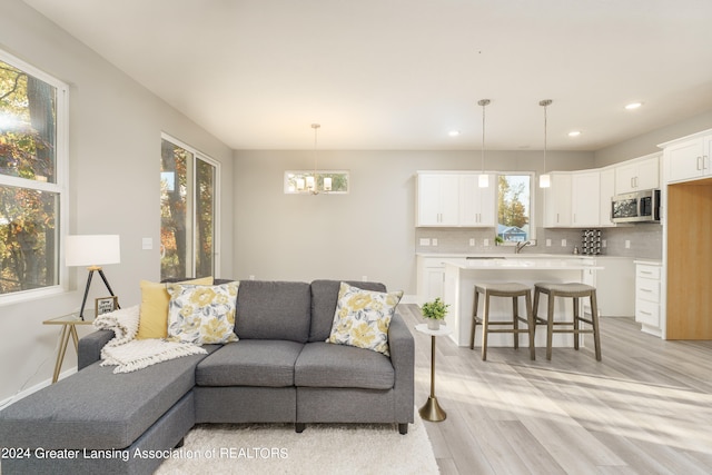 1534 Lytell Johnes Path # 76, Williamston, MI 48895 - living area with light wood-style flooring, a chandelier, and recessed lighting