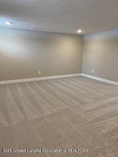 empty room with carpet and baseboards