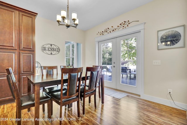 dining area featuring an inviting chandelier, french doors, and light hardwood / wood-style floors