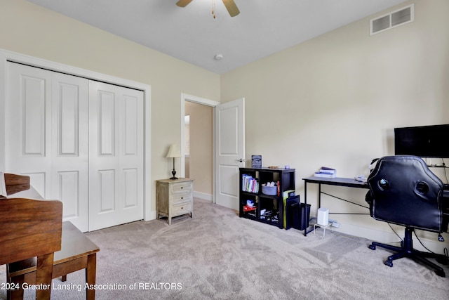 office area with ceiling fan and light carpet