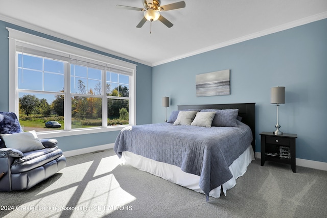 carpeted bedroom with ceiling fan and crown molding