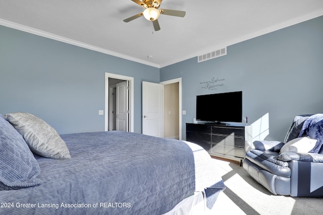 carpeted bedroom with crown molding and ceiling fan