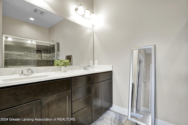 bathroom with vanity and a shower with shower door