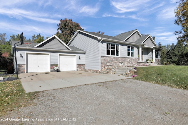 view of front of property featuring a garage and a front lawn