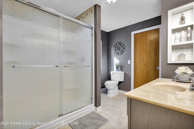 bathroom featuring walk in shower, vanity, and toilet