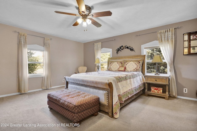 bedroom featuring ceiling fan and light carpet