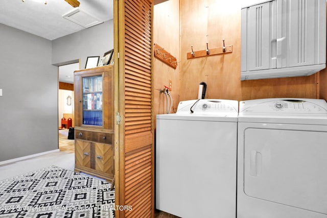 laundry area with cabinets and washing machine and dryer