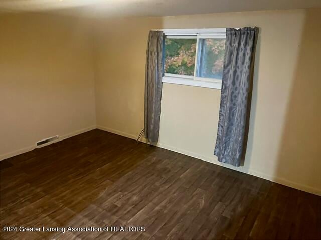 unfurnished room featuring dark hardwood / wood-style floors