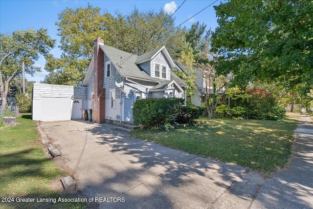 view of home's exterior with a lawn and an outbuilding