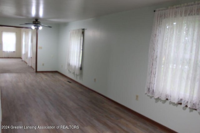 empty room with ceiling fan and hardwood / wood-style flooring