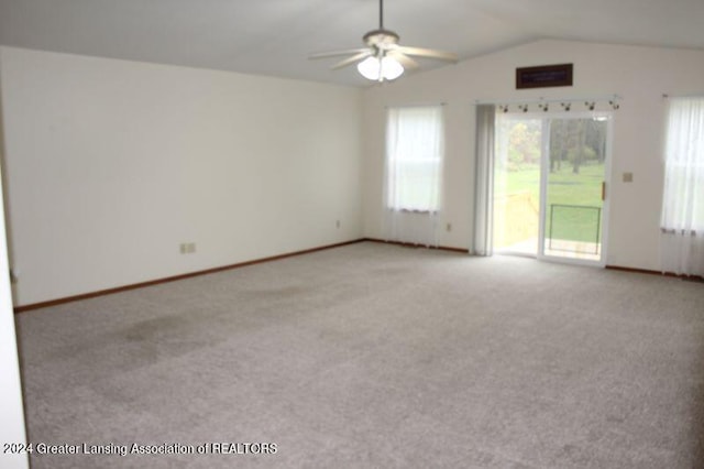 unfurnished room featuring lofted ceiling, light colored carpet, and ceiling fan