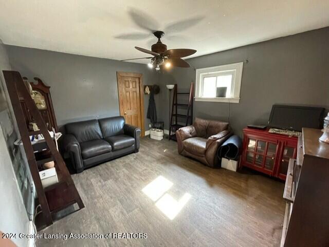 living room with hardwood / wood-style flooring and ceiling fan