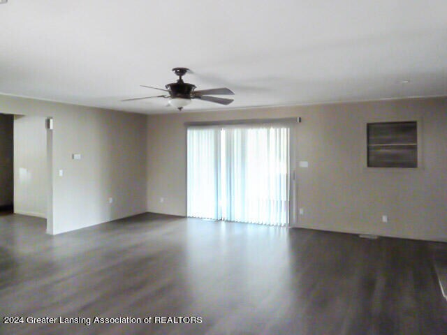 empty room featuring ceiling fan and dark hardwood / wood-style floors