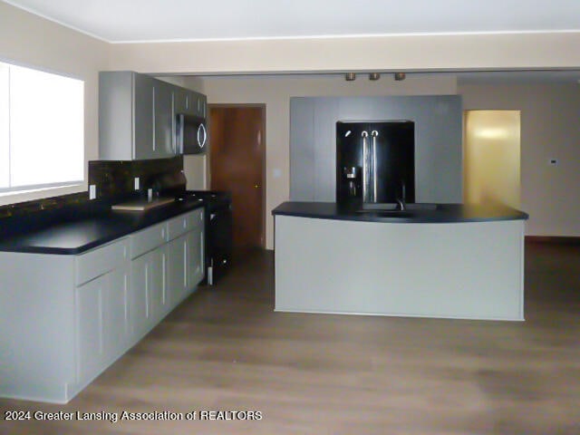 kitchen featuring white cabinets, stainless steel appliances, and light wood-type flooring