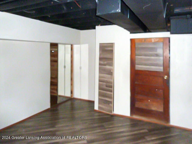 basement featuring dark hardwood / wood-style floors