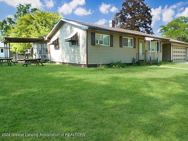 view of front of property with a front lawn and a garage