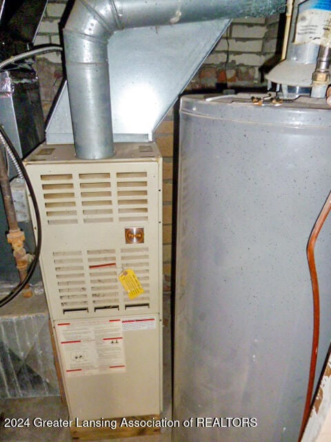 utility room featuring water heater