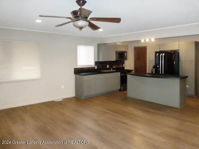 kitchen featuring black refrigerator, gray cabinetry, light wood-type flooring, and ceiling fan