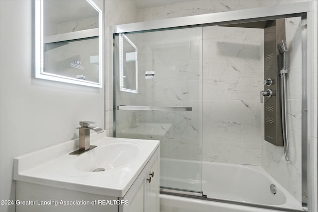 bathroom with vanity and enclosed tub / shower combo