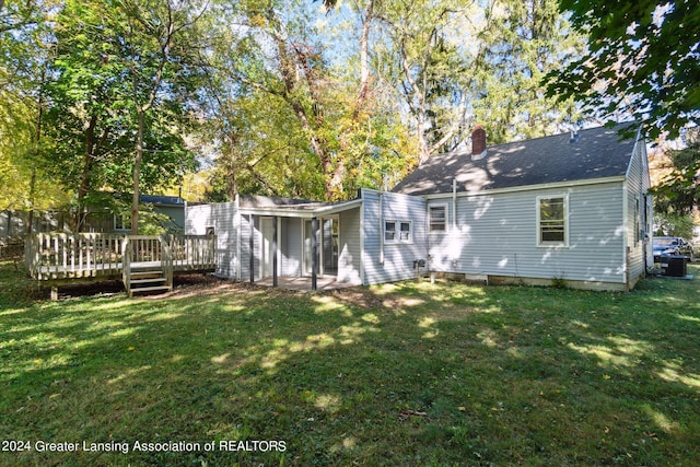 back of house featuring a yard and a deck